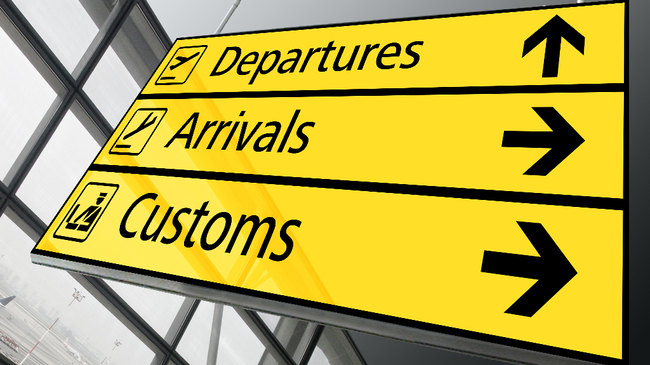 Directional signage for Customs at Manchester Airport, emphasizing the importance of customs clearance.
