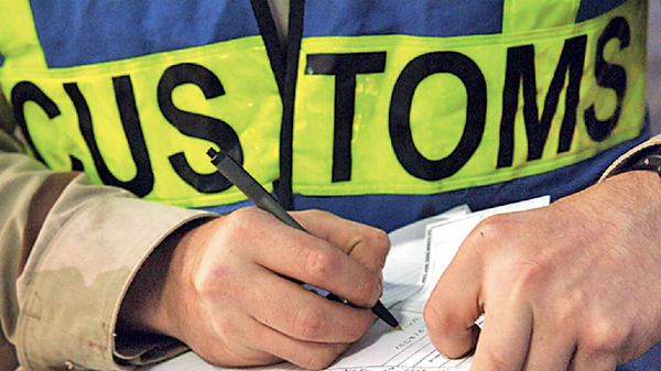 Customs officer reviewing documents for customs clearance procedures